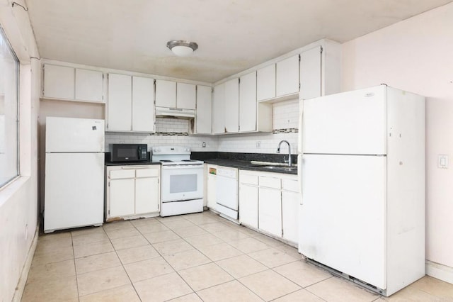 kitchen with backsplash, sink, light tile patterned floors, white appliances, and white cabinets