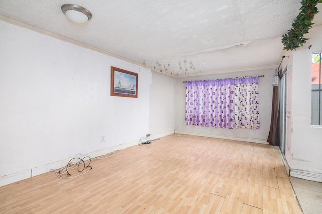 empty room with a textured ceiling and hardwood / wood-style flooring