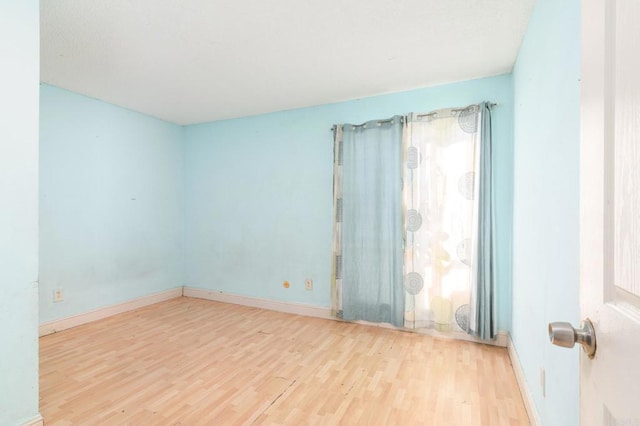 spare room with light wood-type flooring