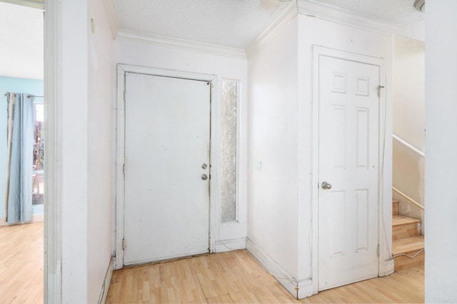 entrance foyer with light wood-type flooring and ornamental molding