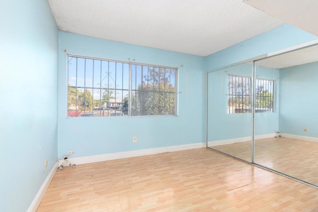 unfurnished bedroom featuring a closet and light hardwood / wood-style flooring