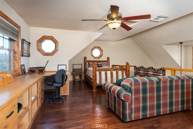 bedroom with built in desk, ceiling fan, vaulted ceiling, and dark wood-type flooring