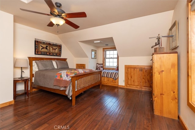 bedroom with ceiling fan, vaulted ceiling, and dark wood-type flooring