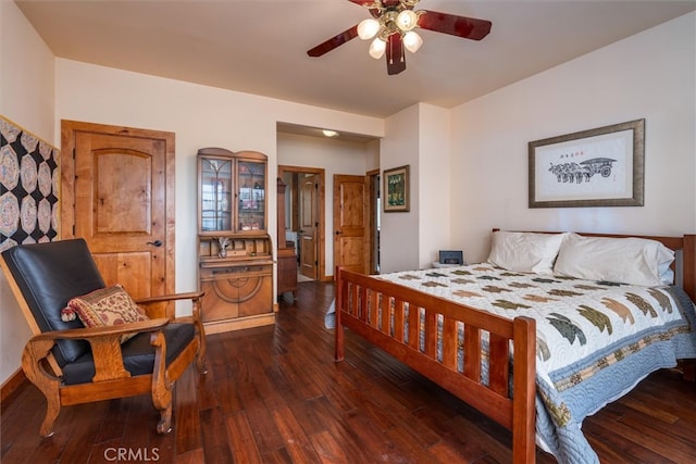 bedroom featuring ceiling fan and dark hardwood / wood-style floors