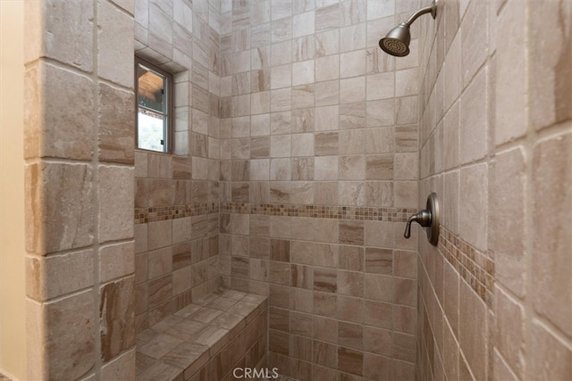 bathroom with tiled shower