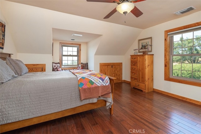 bedroom with vaulted ceiling, ceiling fan, and dark hardwood / wood-style floors