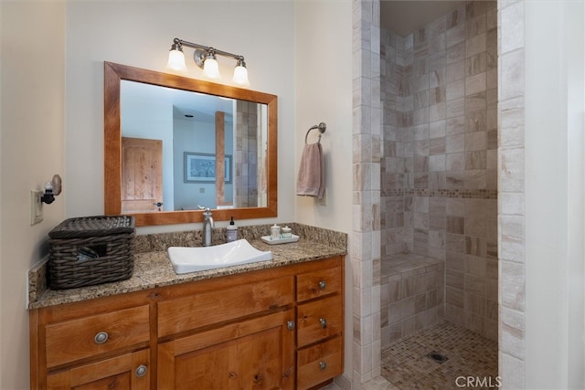 bathroom featuring vanity and tiled shower