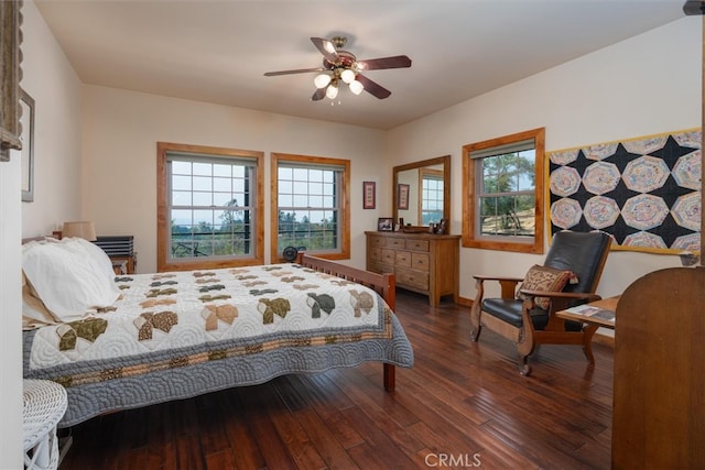 bedroom with ceiling fan, dark hardwood / wood-style flooring, and multiple windows