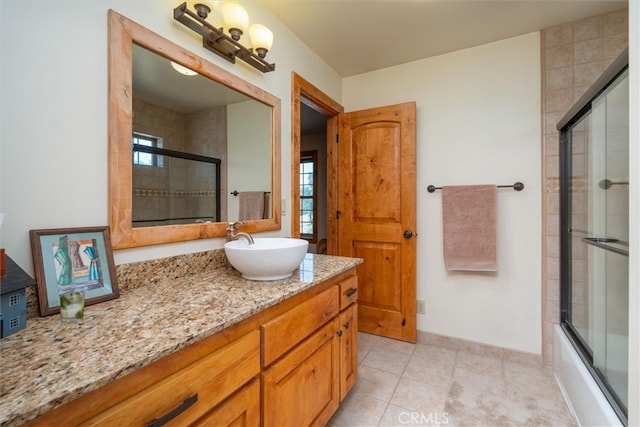 bathroom featuring shower / bath combination with glass door, vanity, plenty of natural light, and tile patterned floors