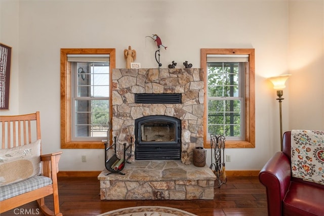 sitting room with plenty of natural light and dark wood-type flooring