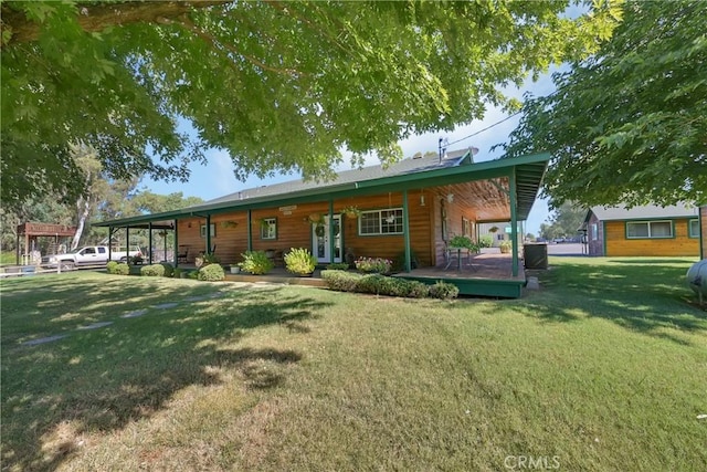 rear view of property with a yard