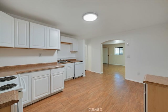 kitchen featuring sink, white cabinets, white appliances, and light wood-type flooring