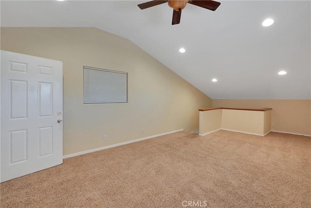 bonus room featuring lofted ceiling, light carpet, and ceiling fan