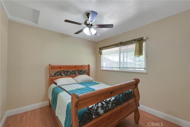 bedroom with wood-type flooring and ceiling fan