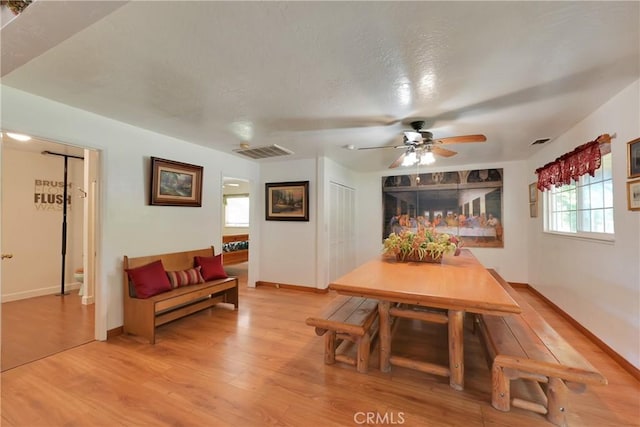 dining space with ceiling fan and hardwood / wood-style floors