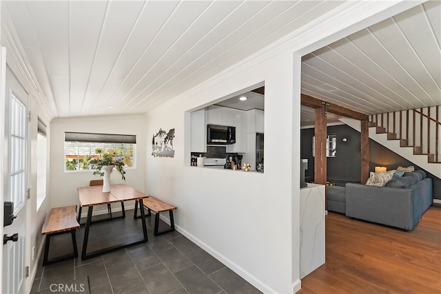 dining space with lofted ceiling and crown molding