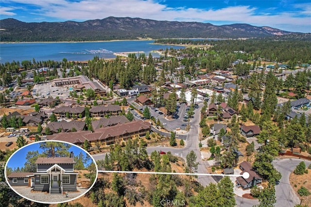 drone / aerial view featuring a water and mountain view