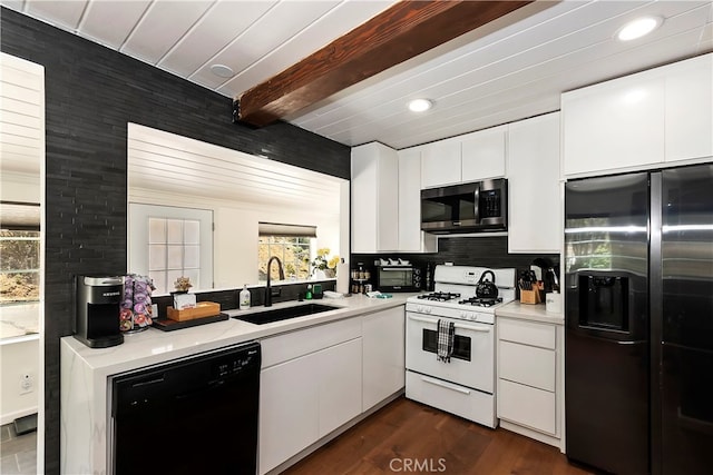 kitchen with beam ceiling, sink, stainless steel appliances, dark hardwood / wood-style floors, and white cabinets