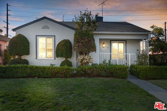 single story home featuring a yard