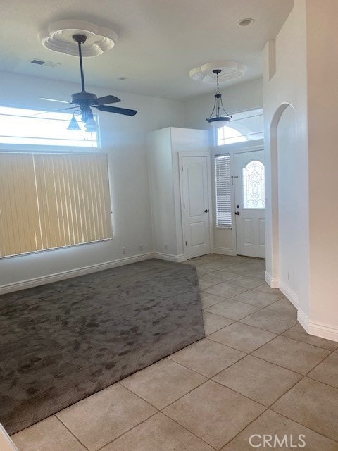 tiled entrance foyer with ceiling fan