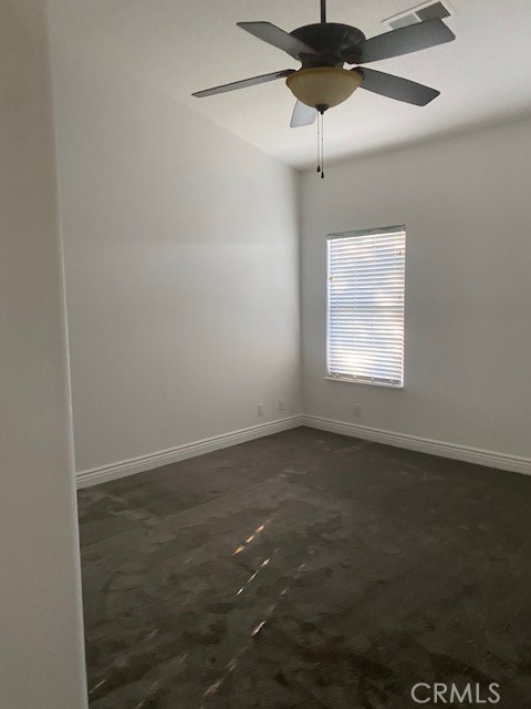 unfurnished room with ceiling fan