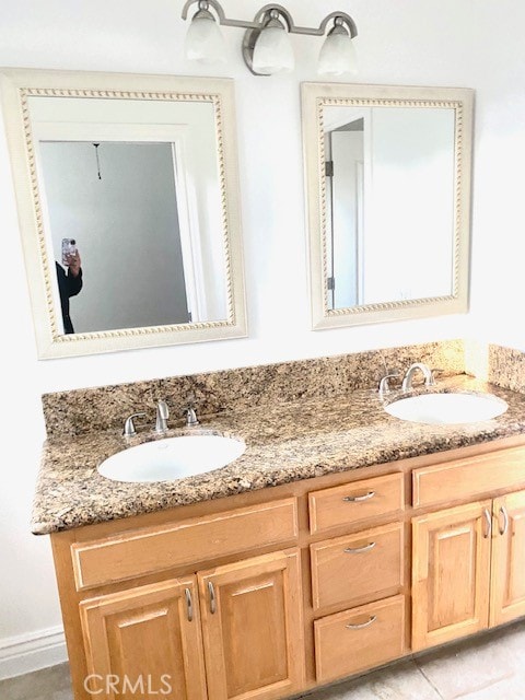 bathroom with tile patterned flooring and vanity