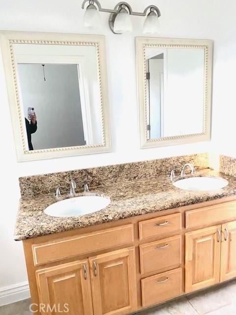 full bath featuring double vanity and a sink