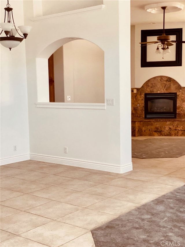 empty room featuring tile patterned flooring and ceiling fan