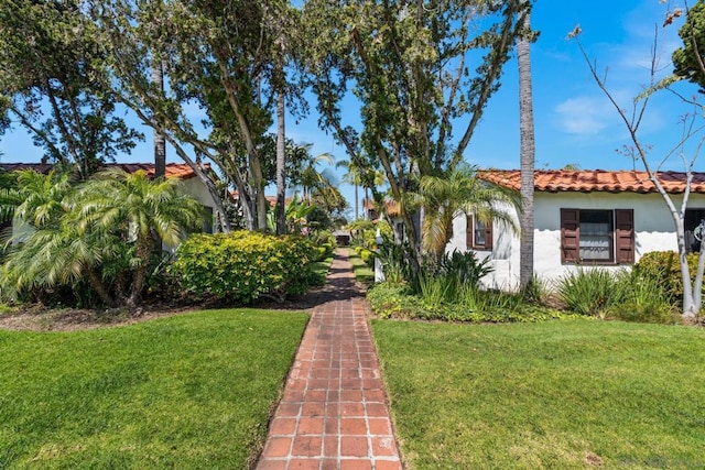 mediterranean / spanish house featuring a front yard