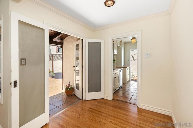 corridor with wood-type flooring and ornamental molding