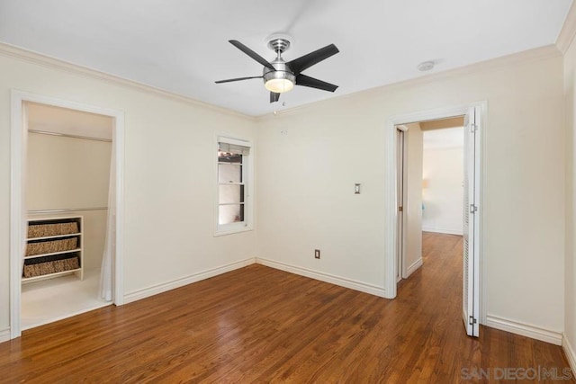 spare room with ceiling fan, dark wood-type flooring, and crown molding