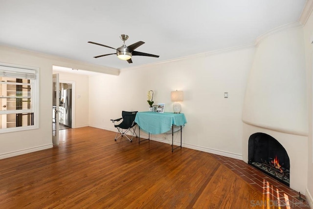 miscellaneous room featuring ceiling fan, a fireplace, hardwood / wood-style floors, and crown molding