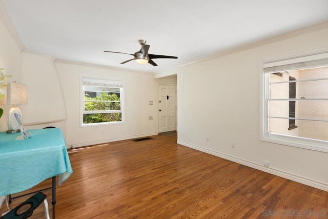 interior space featuring ornamental molding, wood-type flooring, and ceiling fan