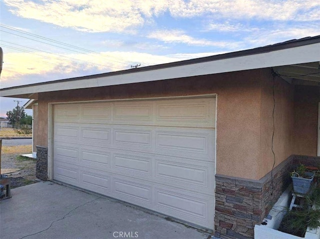 view of garage at dusk