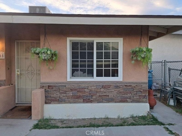 view of exterior entry featuring central AC unit