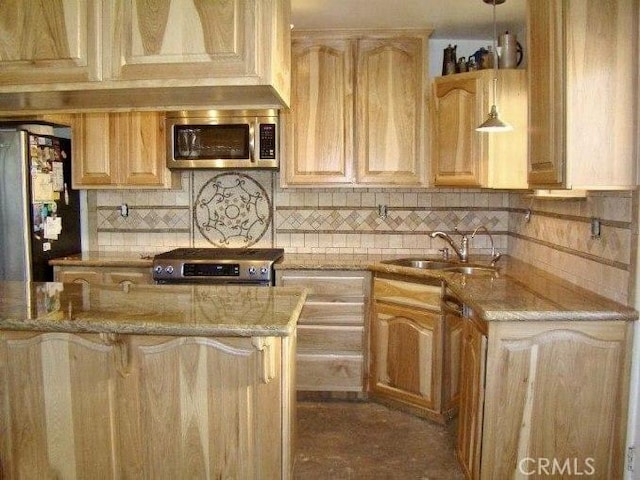 kitchen featuring appliances with stainless steel finishes, light brown cabinetry, pendant lighting, and sink