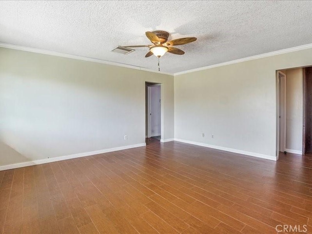 spare room featuring a textured ceiling, crown molding, ceiling fan, and dark wood-type flooring