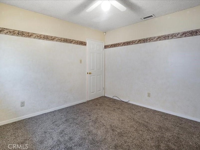 unfurnished room featuring ceiling fan, carpet floors, and a textured ceiling