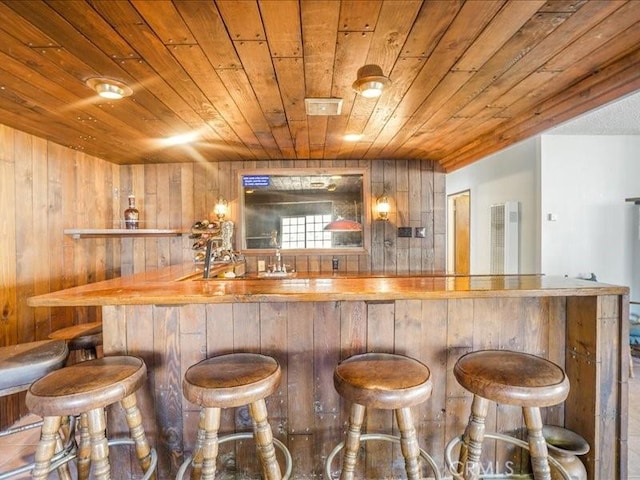 bar featuring wood walls and wood ceiling