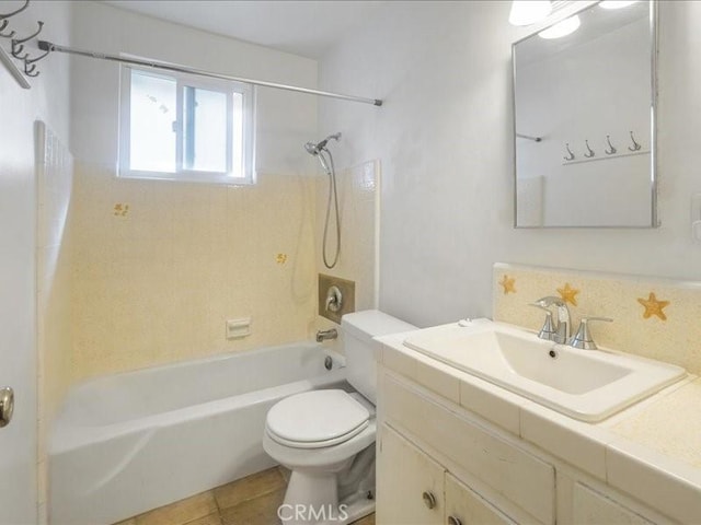 full bathroom featuring tile patterned floors, tiled shower / bath combo, toilet, and vanity