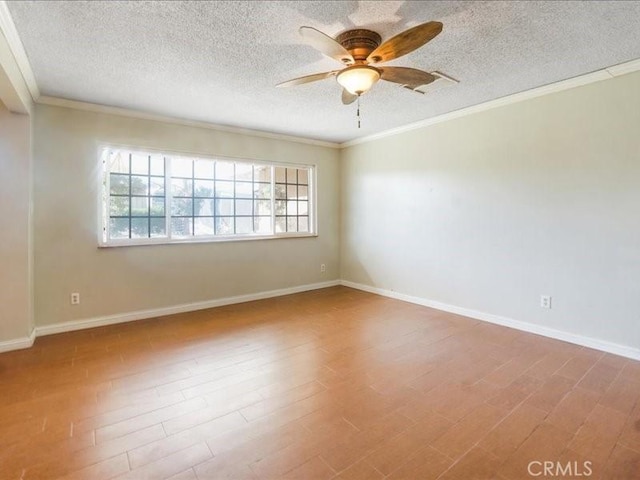 unfurnished room with hardwood / wood-style floors, a textured ceiling, and crown molding