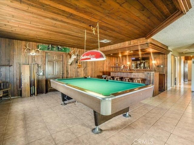 game room featuring wood walls, light tile patterned floors, wood ceiling, and billiards