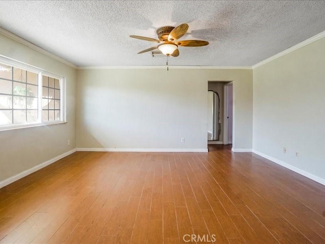 spare room featuring crown molding, hardwood / wood-style floors, ceiling fan, and a textured ceiling