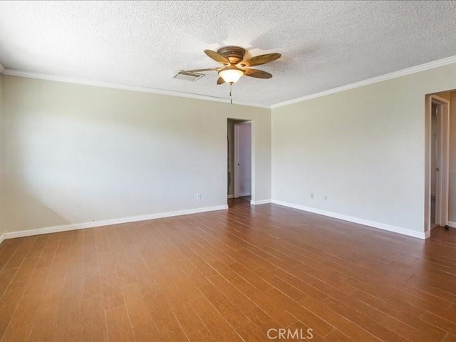 spare room with dark hardwood / wood-style floors, ceiling fan, ornamental molding, and a textured ceiling