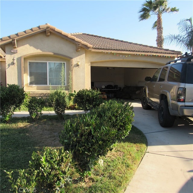 mediterranean / spanish-style home with a garage