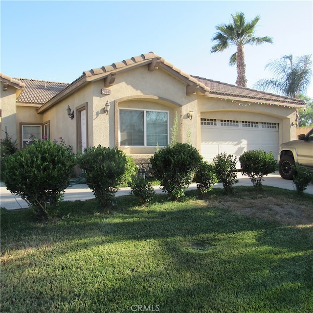 view of front of home with a front lawn and a garage