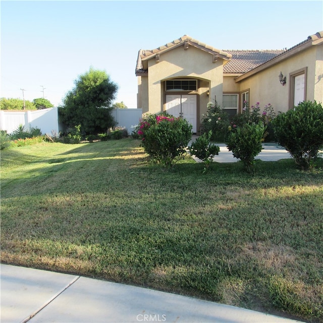 view of side of home with a lawn