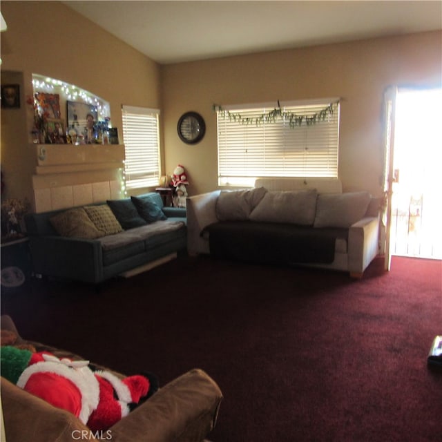 living room with carpet flooring and a tile fireplace