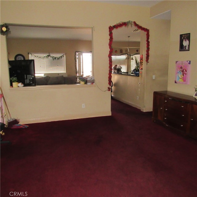 interior space featuring dark colored carpet