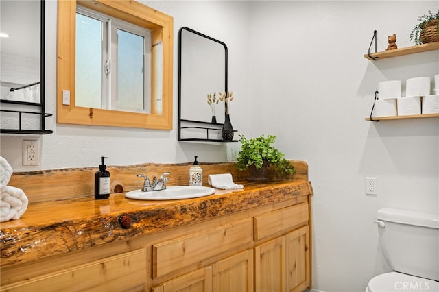 bathroom featuring toilet and vanity